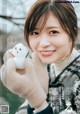 A woman holding a snowman in her hands.